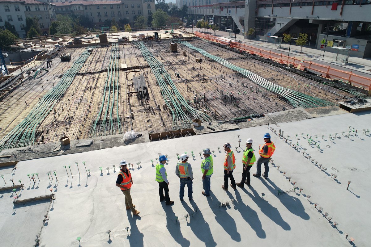 Construction crew reviewing works on a large concrete pour